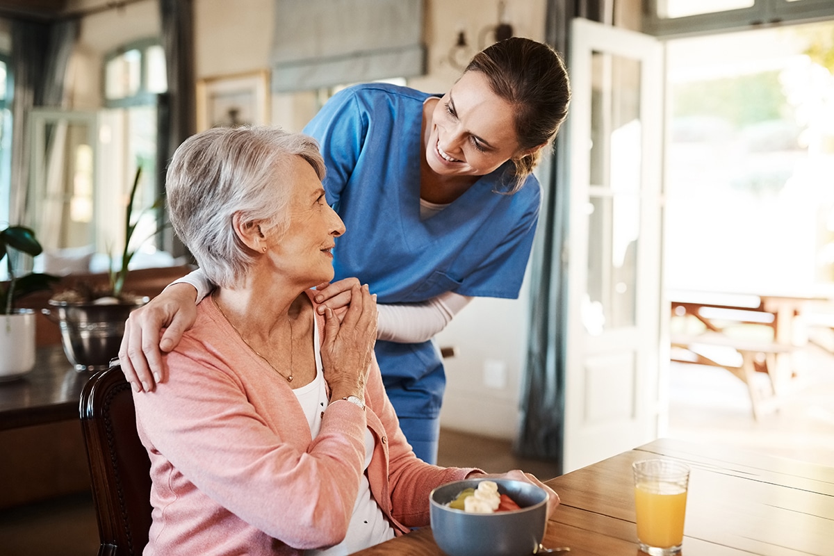 yolo-300x200-85 Healthcare, elderly woman with nurse with breakfast at her home and at the table in living room. Support or communication, caregiver and conversation with medical person with senior or old female.